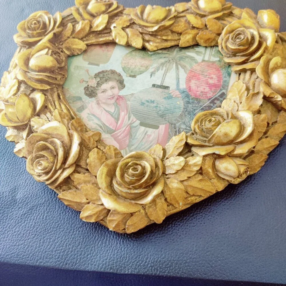 Picture Frames from Nordstroms a heavy gold heart frame with Roses & Leaf Border